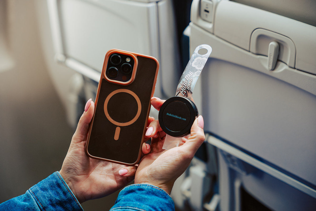 Clear Mo'Bettah Airplane Phone Holder attached to a MagSafe-compatible iPhone