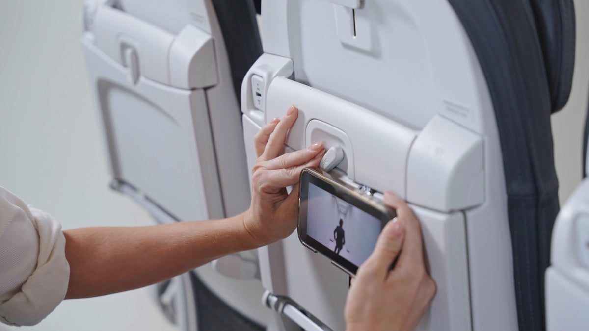 Mo'Bettah Airplane Phone Holder attached to an airplane tray table for hands-free viewing