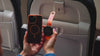 Mo'Bettah Airplane Phone Holder demonstrated on an airplane seat for hands-free in-flight entertainment